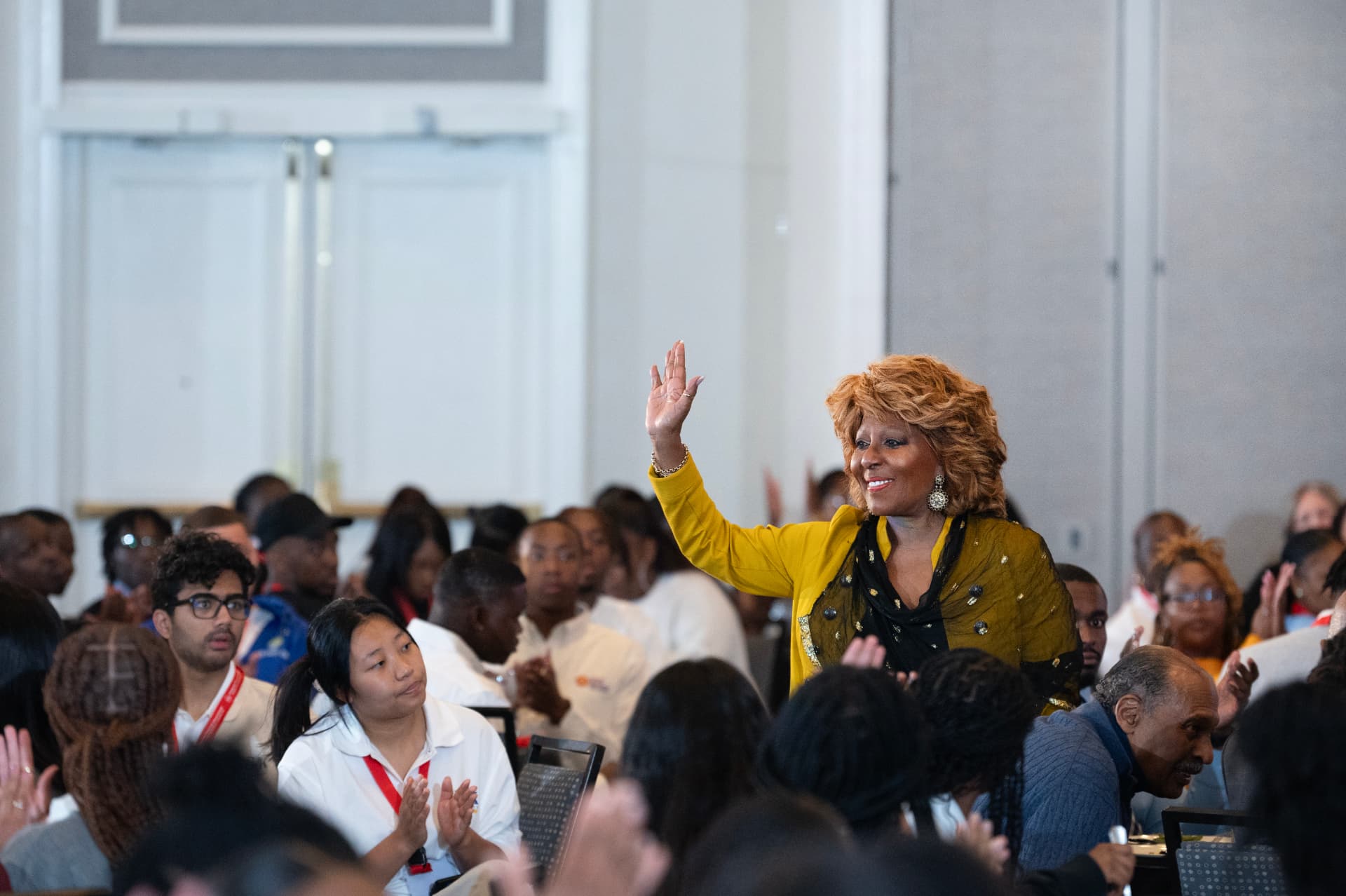 Marcia Griffin greeting an audience of students at a leadership summit